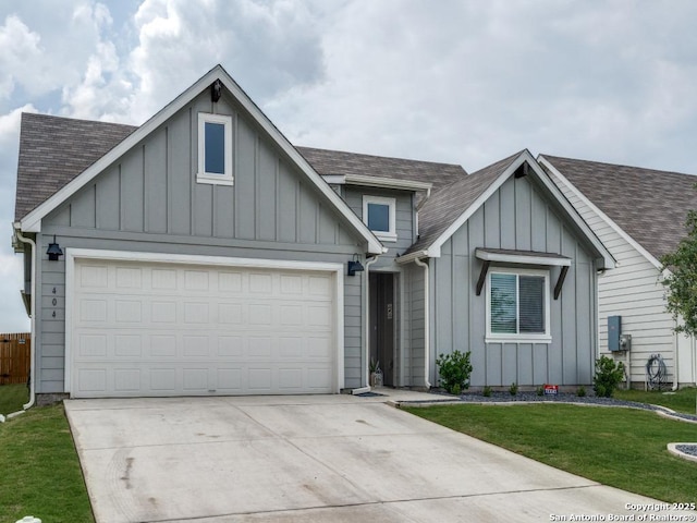 view of front of home featuring a front lawn, board and batten siding, a shingled roof, and concrete driveway