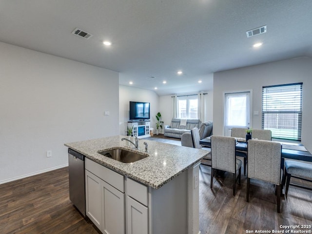 kitchen featuring recessed lighting, stainless steel dishwasher, a sink, visible vents, and dark wood-type flooring