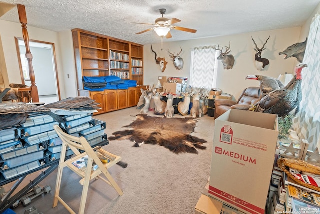 living room featuring a textured ceiling, ceiling fan, and light colored carpet
