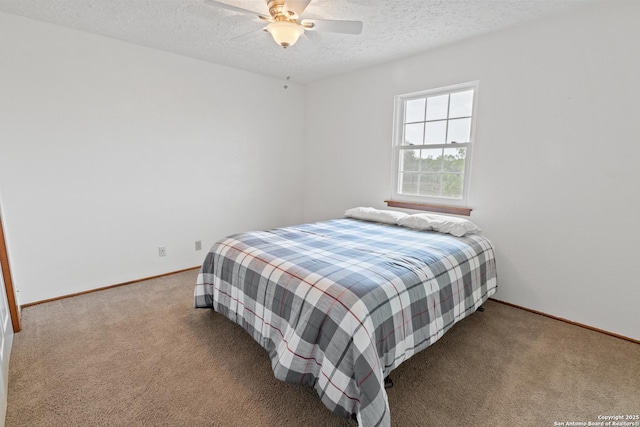 bedroom with a textured ceiling, ceiling fan, carpet flooring, and baseboards