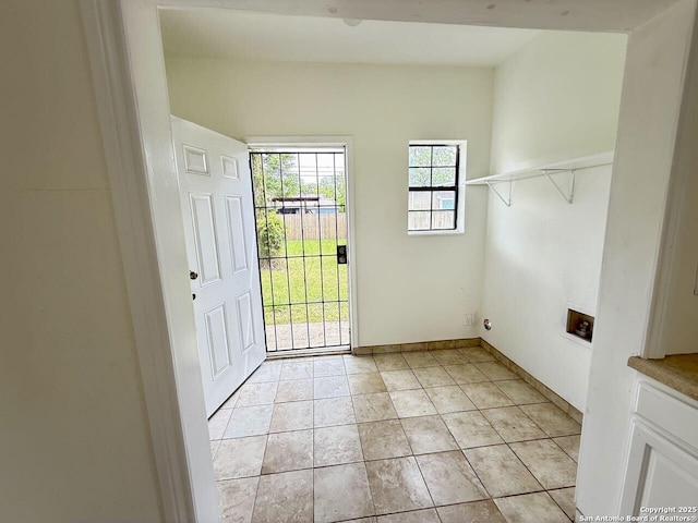 doorway featuring baseboards