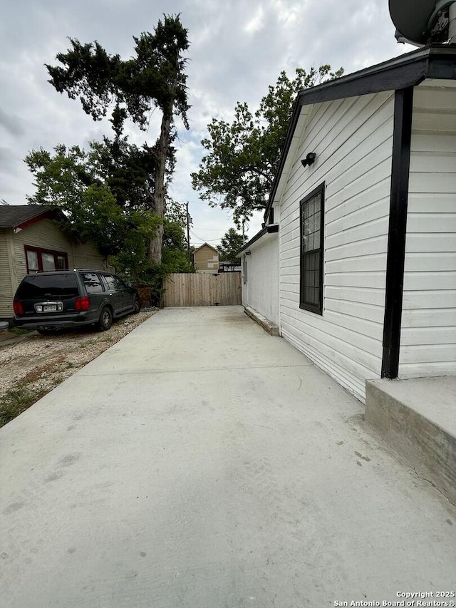 view of side of property featuring fence