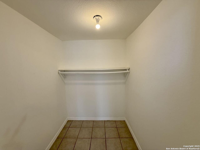 spacious closet featuring tile patterned floors