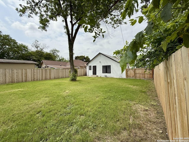 view of yard with a fenced backyard