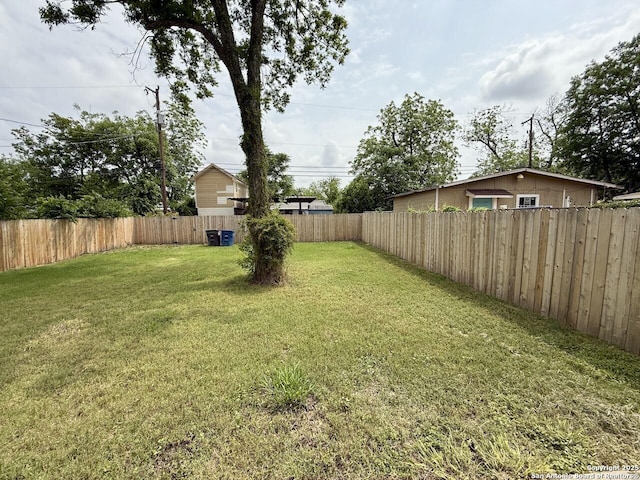 view of yard with a fenced backyard