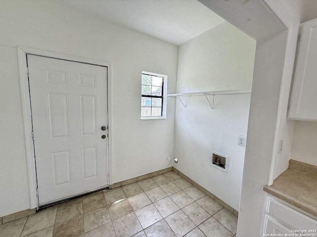 washroom featuring cabinet space, washer hookup, and baseboards