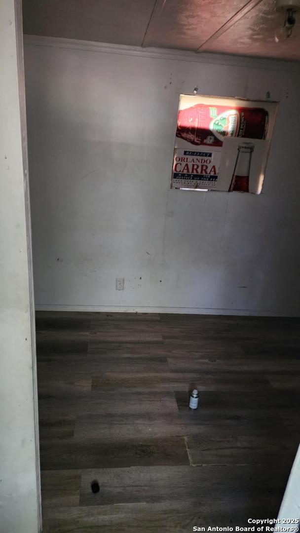 unfurnished room with wood finished floors