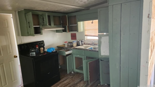kitchen featuring black electric range, a sink, under cabinet range hood, and dark wood-type flooring