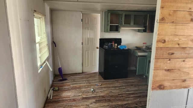 kitchen featuring washer / clothes dryer and dark wood-type flooring