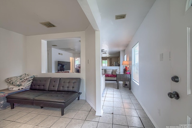 interior space featuring light tile patterned floors, visible vents, and baseboards