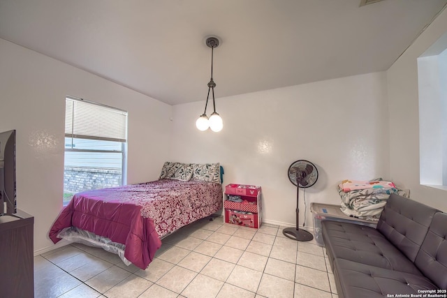 bedroom featuring light tile patterned floors and baseboards