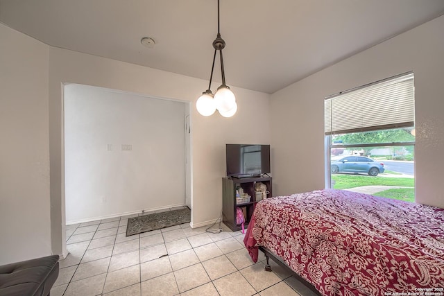 bedroom featuring light tile patterned floors and baseboards