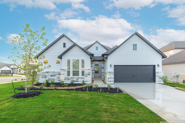 modern inspired farmhouse featuring stone siding, a front lawn, driveway, and stucco siding