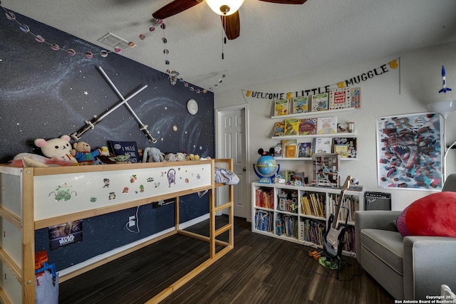 game room featuring visible vents, wood finished floors, ceiling fan, and a textured ceiling