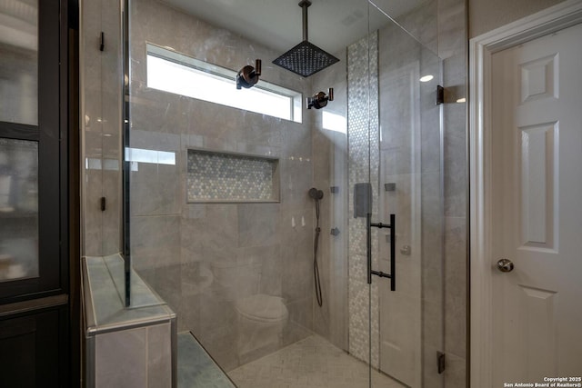 full bathroom with a stall shower and toilet