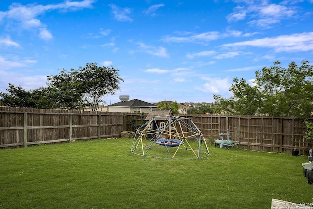 view of yard featuring a fenced backyard and a playground