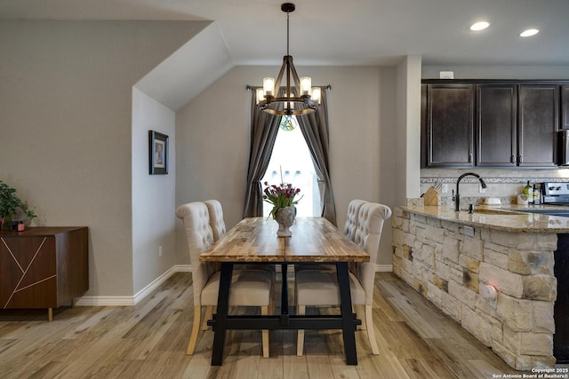 dining area featuring lofted ceiling, a chandelier, baseboards, light wood-type flooring, and recessed lighting