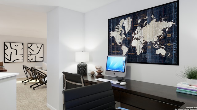 carpeted home office featuring baseboards