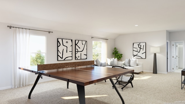 dining space featuring baseboards, light carpet, and vaulted ceiling