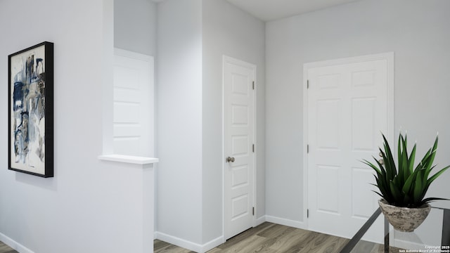 hallway with light wood finished floors and baseboards