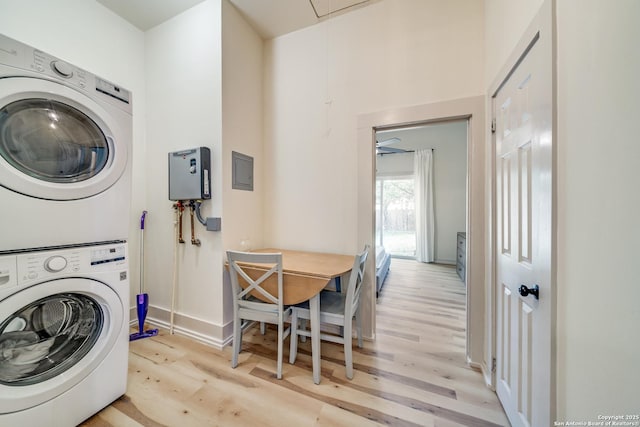 washroom with stacked washer and dryer, baseboards, attic access, light wood-type flooring, and laundry area