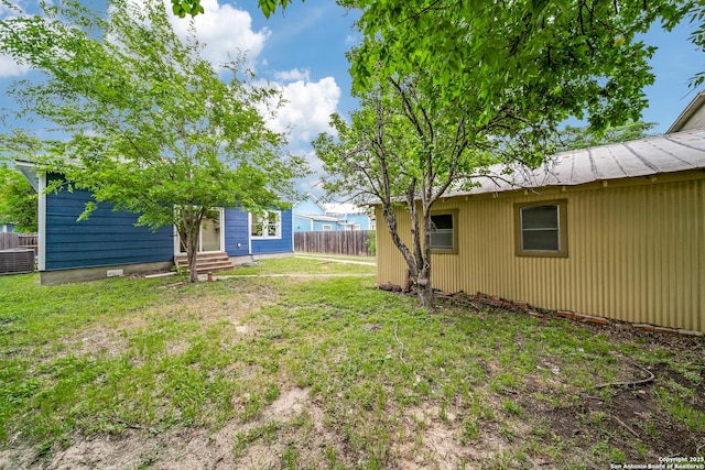 view of yard featuring fence and entry steps