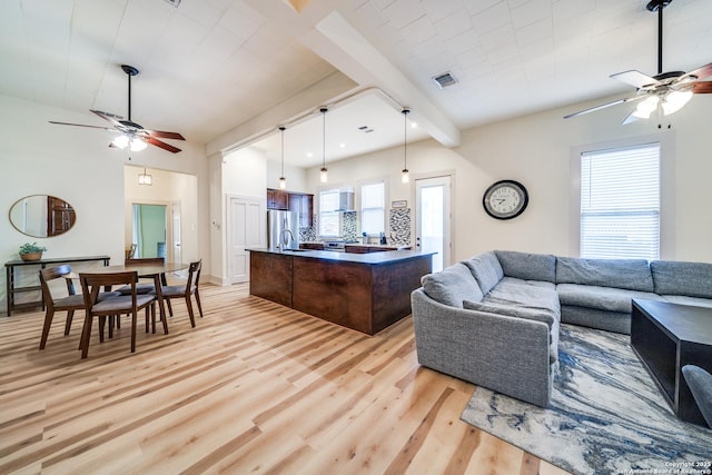 living area featuring visible vents, ceiling fan, and light wood finished floors