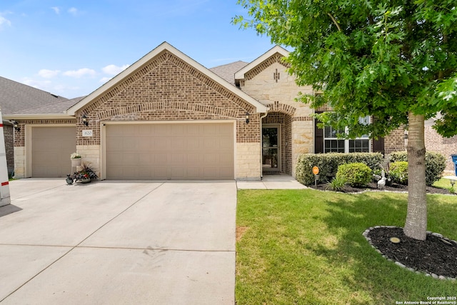 view of front facade with an attached garage, a front yard, brick siding, and concrete driveway