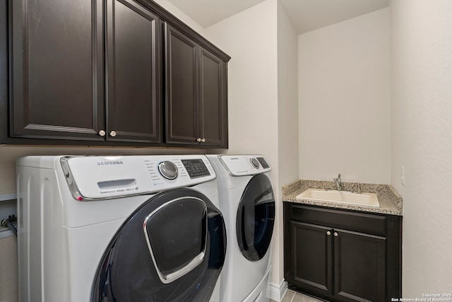 laundry area with a sink, cabinet space, and washer and clothes dryer
