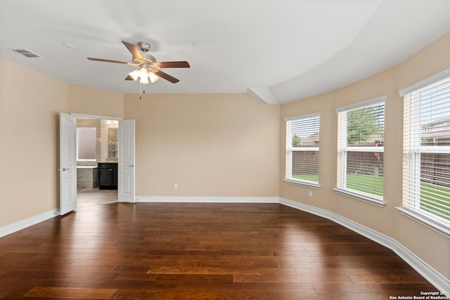 spare room featuring visible vents, dark wood-type flooring, baseboards, and ceiling fan