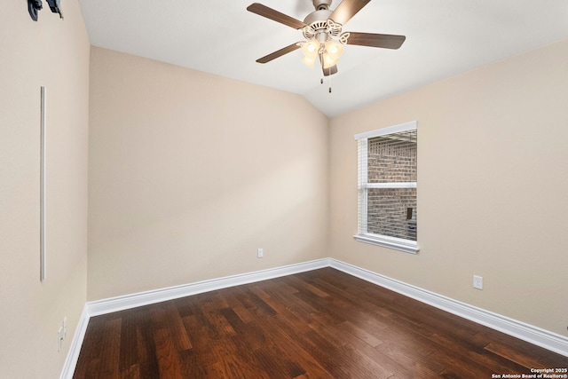 spare room featuring baseboards, a ceiling fan, dark wood finished floors, and lofted ceiling