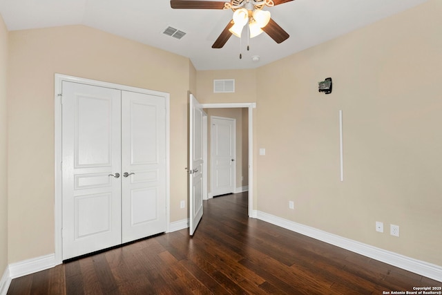 unfurnished bedroom with baseboards, a closet, dark wood-style flooring, and visible vents