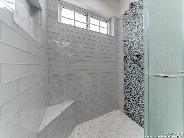 full bath featuring tiled shower