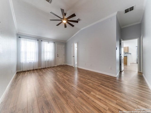 unfurnished living room featuring lofted ceiling, visible vents, and crown molding