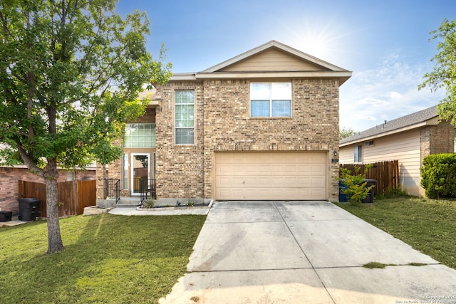 traditional home with a front yard, driveway, an attached garage, and fence