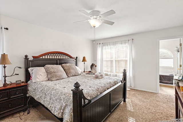 bedroom with light carpet, ensuite bath, multiple windows, and ceiling fan