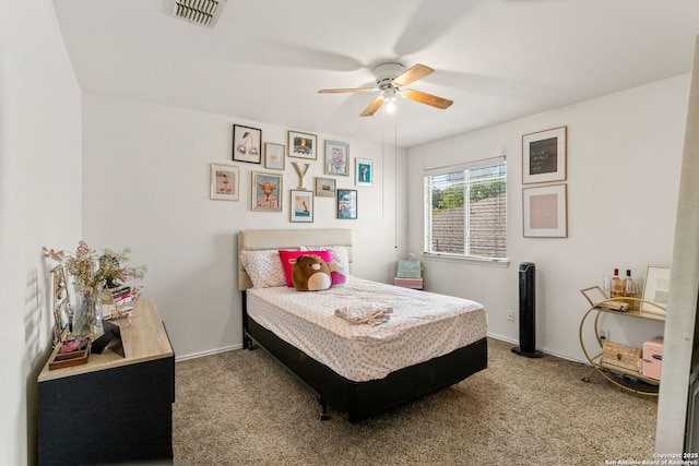 carpeted bedroom with baseboards, visible vents, and a ceiling fan