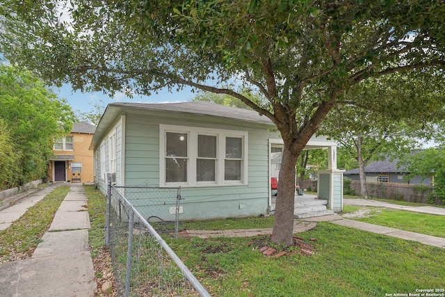 view of front of home with a front lawn and fence