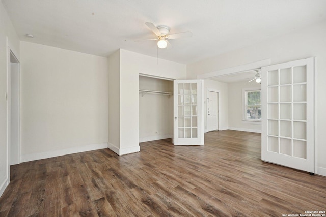 unfurnished bedroom featuring a closet, ceiling fan, wood finished floors, and baseboards