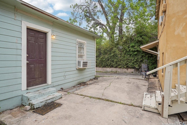 property entrance with a patio and cooling unit