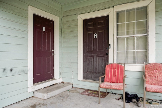 view of exterior entry featuring a porch
