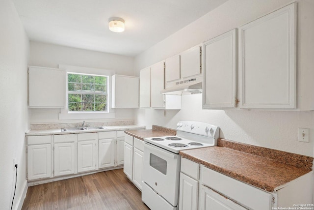 kitchen featuring white range with electric stovetop, white cabinetry, a sink, and under cabinet range hood