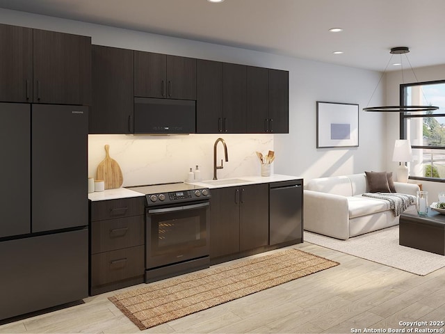 630 Central Pkwy Unit 1113, New Braunfels, TX 78130 - kitchen featuring black appliances, tasteful backsplash, light wood-type flooring, and a sink