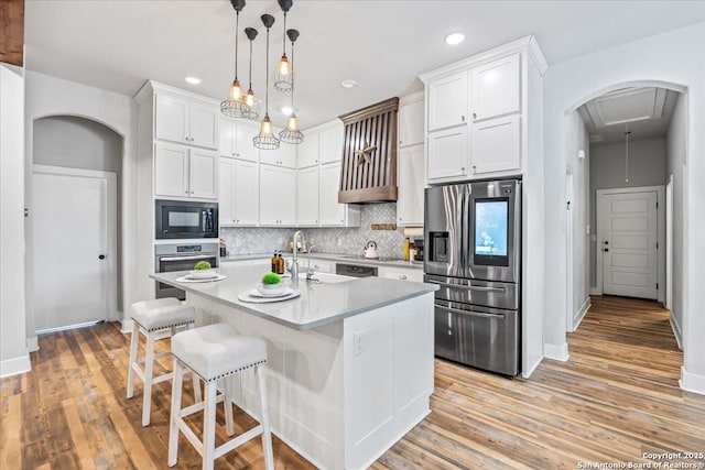 1547 Moon Vw, New Braunfels, TX 78132 - kitchen featuring stainless steel appliances, decorative backsplash, white cabinets, a breakfast bar area, and light countertops