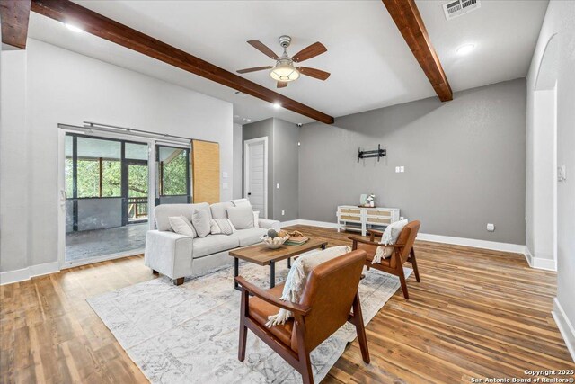 1547 Moon Vw, New Braunfels, TX 78132 - living room with beamed ceiling, ceiling fan, baseboards, and wood finished floors