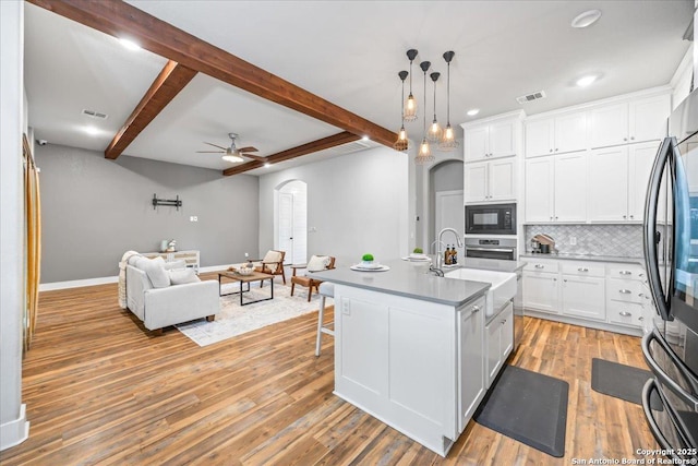 1547 Moon Vw, New Braunfels, TX 78132 - kitchen featuring black appliances, arched walkways, open floor plan, baseboards, and a ceiling fan