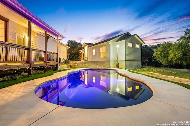 1547 Moon Vw, New Braunfels, TX 78132 - pool at dusk with an outdoor pool, a wooden deck, and cooling unit