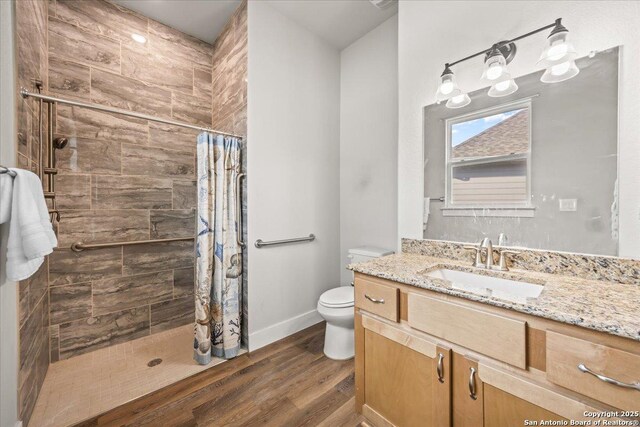 1547 Moon Vw, New Braunfels, TX 78132 - full bathroom featuring wood finished floors, toilet, vanity, and tiled shower