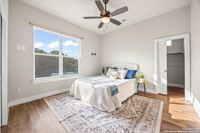 1547 Moon Vw, New Braunfels, TX 78132 - bedroom with wood finished floors, baseboards, and a spacious closet