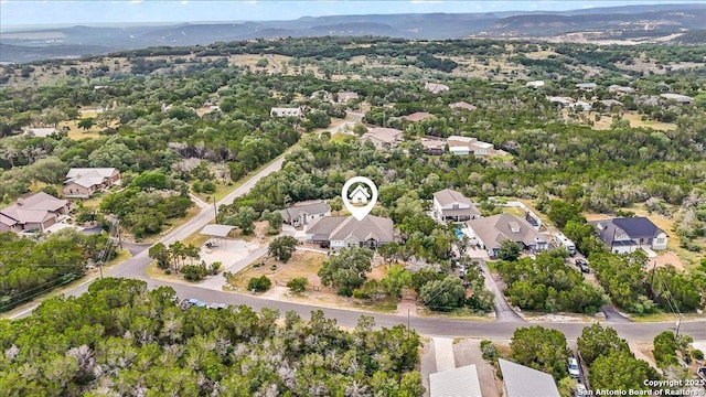 1547 Moon Vw, New Braunfels, TX 78132 - aerial view of property's location featuring nearby suburban area and a mountain backdrop